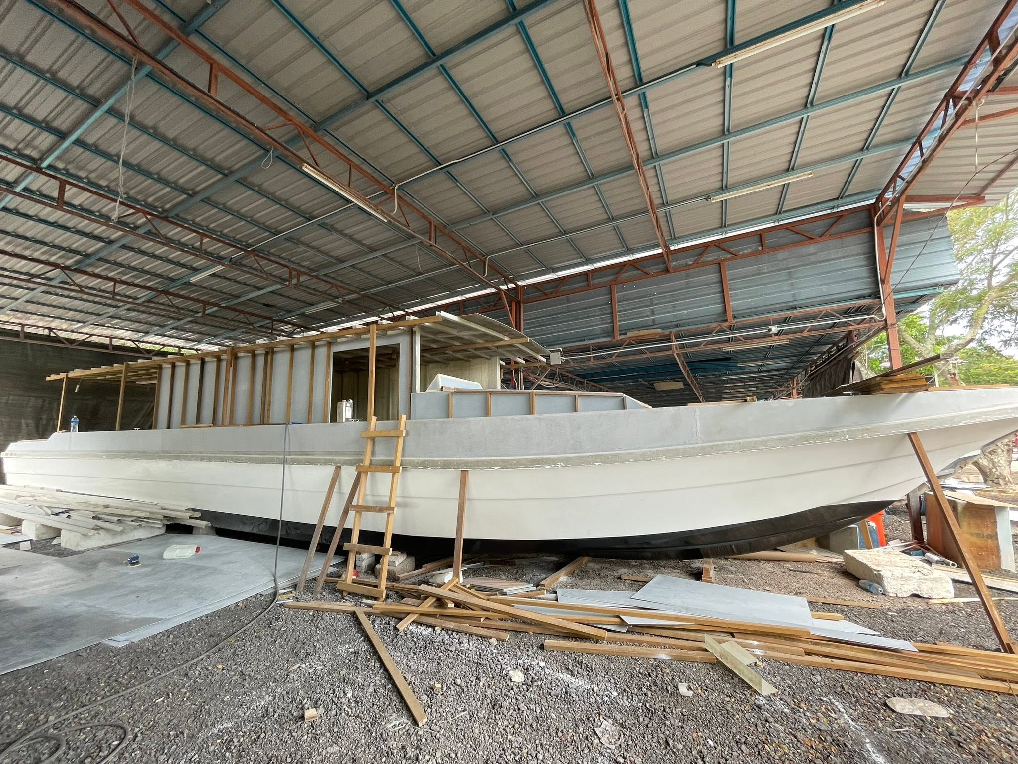 Broadside view of a working vessel during exterior shaping and finishing